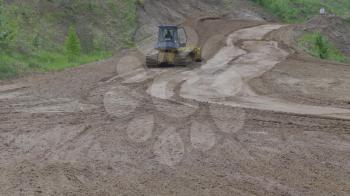Bulldozer on tracks at the mountain road construction. UltraHD stock footage.