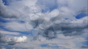Time lapse Fluffy clouds float across the blue sky. UltraHD stock footage.