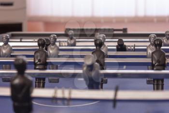 Table football in the entertainment center. Close-up image of plastic players in a football game.