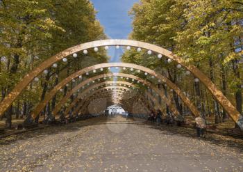 Sokolniki park, sunny autumn day wooden arch.