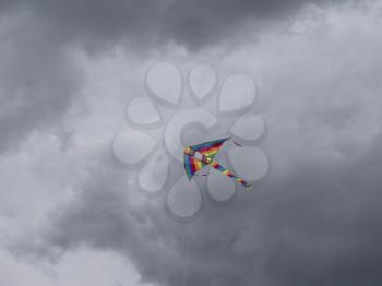 Multicolored kite soaring in the sky.