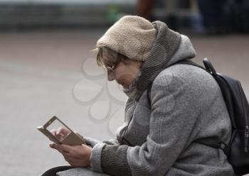 MOSCOW - SEPTEMBER 27: woman looking at smartphone on Old Arbat Street on September 27, 2010 in Moscow, Russia.