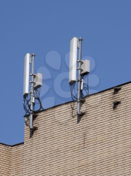 Mobile communication antennas on the wall of a building.