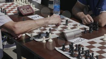 Chess players play a game of chess in a tournament.