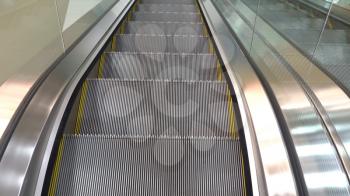 Moving escalator up in a public area.