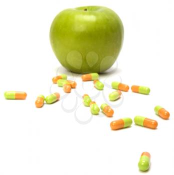 apple and pills isolated on white background