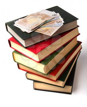 Money over book stack.  Education  concept