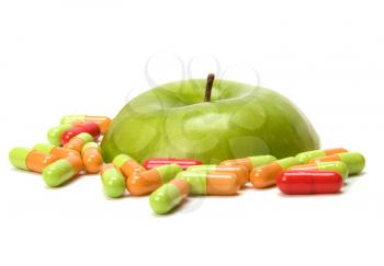 sliced apple and pills isolated on white background