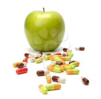apple and pills isolated on white background
