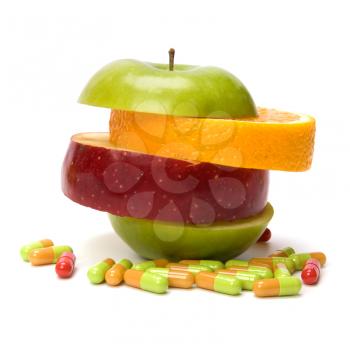 mixed sliced fruits and pills isolated on white background