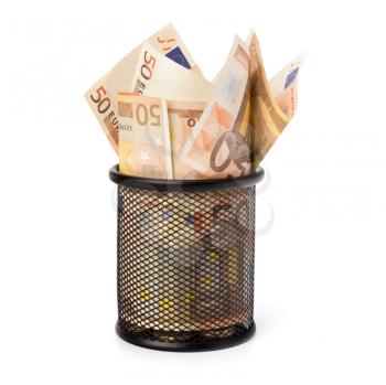Waste of money concept. Euro currency in garbage bin isolated on white background.