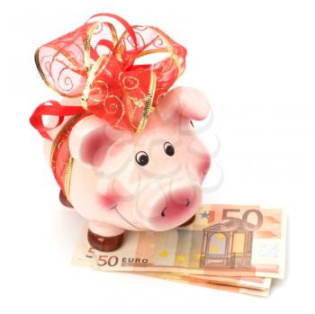 Christmas deposit concept. Piggy bank with festive bow isolated on white.