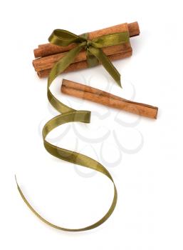 Festive wrapped cinnamon sticks isolated on white background