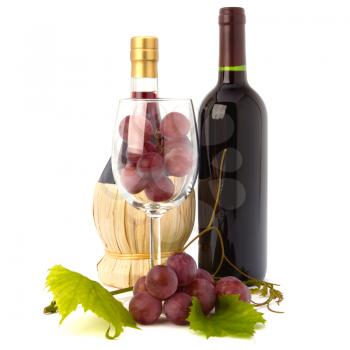 wine glass full with grapes and two wine bottles  isolated on white background