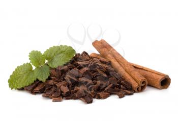 Crushed chocolate shavings pile and cinnamon sticks isolated on white background