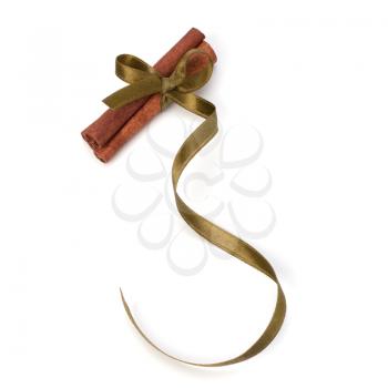 Festive wrapped cinnamon sticks isolated on white background