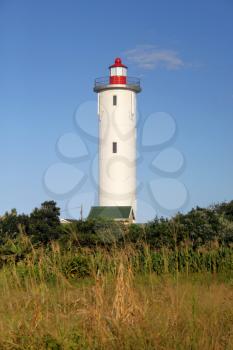 Portrait Picture of a Lighthouse During Daytime and Blue Skies