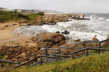 Picture of Coastal Town with Wooden Steps and Concrete Jetty in Storm