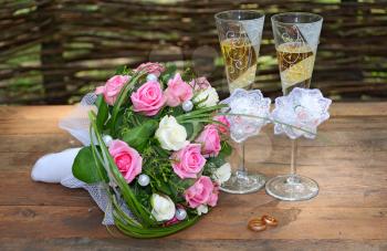 a wedding bouquet is glasses with champagne and rings