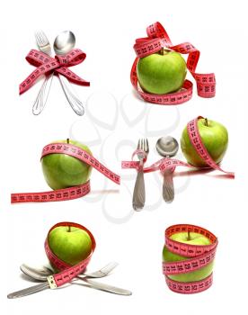 spoon fork and apple is strung by a ribbon for measuring diet isolated on white background