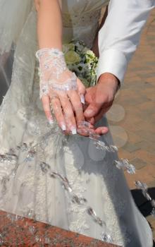 water splashing on two hands of the newlyweds