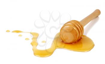 honey flowing down from a wooden stick isolated on white background