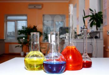 laboratory beakers with the coloured liquid