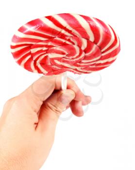 candy pink spiral lollipop in hand isolated on white background