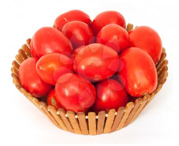 fresh tomatoes on green branch in wicker basket isolated on white background 