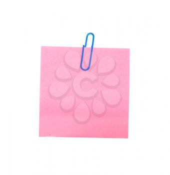 Pink sticker note with a blue push-pin over white paper 
