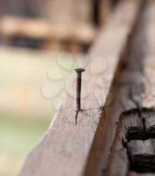 rusty nail in old wood, shallow focus 
