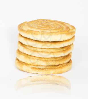 Flapjack chocolate chip cookie stack with one alone, isolated over white background with reflection. 