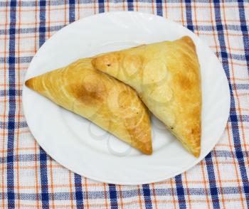 Two traditional South African Samoosa triangles filled with chicken and beef mince 