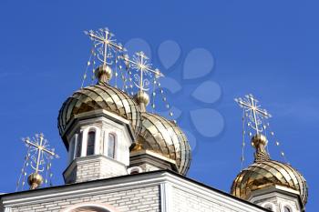 Golden dome of the Orthodox church with blue sky background, Russia. 
