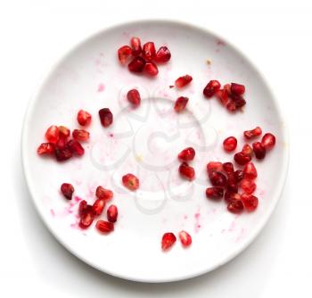 Pomegranate on a plate on a white background