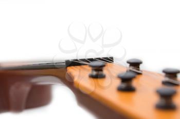 Headstock of the guitar over white background 