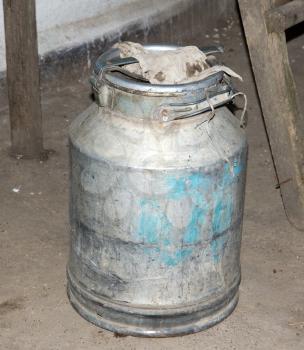 The old aluminium tank for water and honey