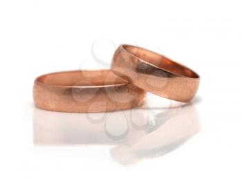 wedding rings with reflection on white background