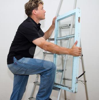 a man with a window on a ladder on a white background
