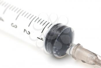 syringe on a white background. macro