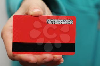 red plastic card in hand