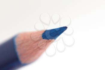 blue pencil on a white background. macro