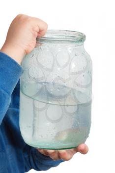 jar of water in the hands of the boy