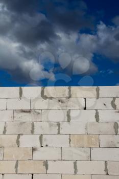 beautiful background of a brick wall and sky with clouds
