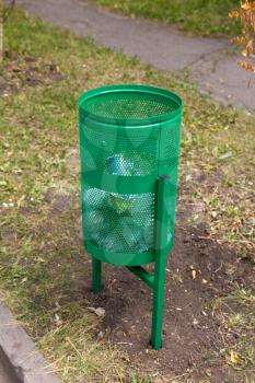 green rubbish bin in nature