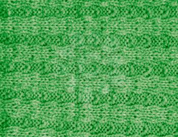 green knitted fabric as a background. macro
