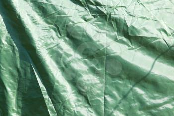 Green crumpled fabric as background