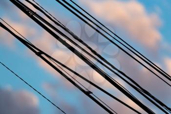 Electric wires at sunset as an abstract background