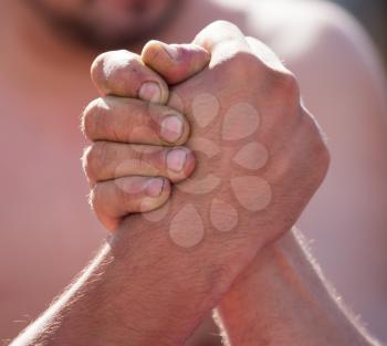 Two men's hands in comparison strength .