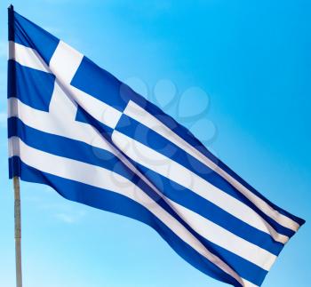Flag of Greece against the blue sky .